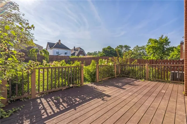 a view of a pathway with a wrought fence