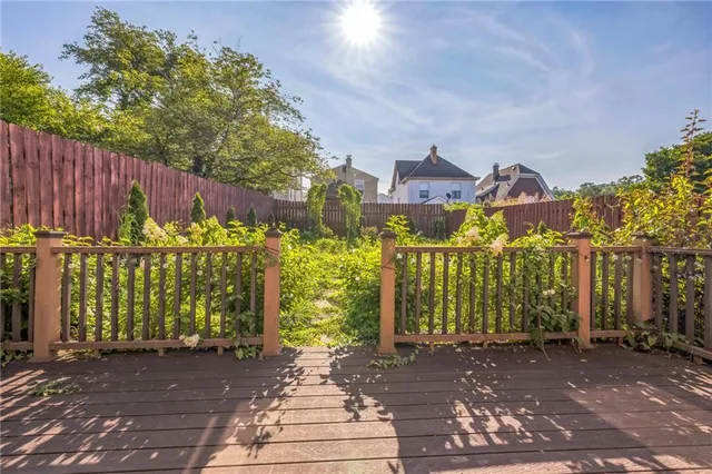 a view of a brick house with many windows next to a yard