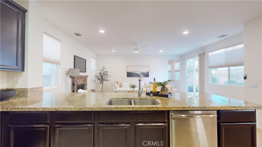 28620 Vista Del Rio Drive Valencia, CA 91354 - Photo 12 of 40 a kitchen with kitchen island granite countertop a sink and cabinets