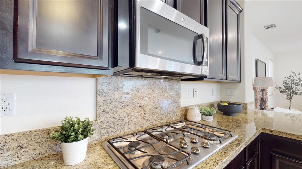 28620 Vista Del Rio Drive Valencia, CA 91354 - Photo 13 of 40 a kitchen with a stove and a microwave