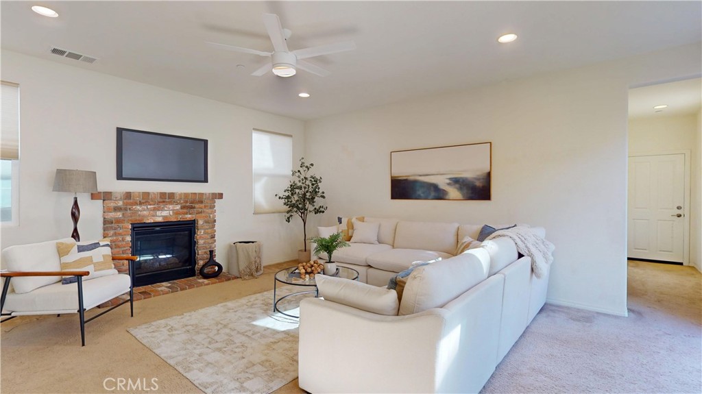 28620 Vista Del Rio Drive Valencia, CA 91354 - Photo 17 of 40 a living room with furniture a fireplace and a flat screen tv