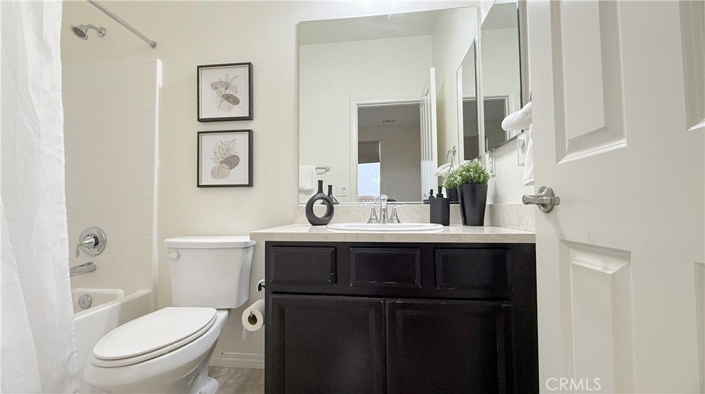 28620 Vista Del Rio Drive Valencia, CA 91354 - Photo 20 of 40 a bathroom with a toilet a sink and mirror