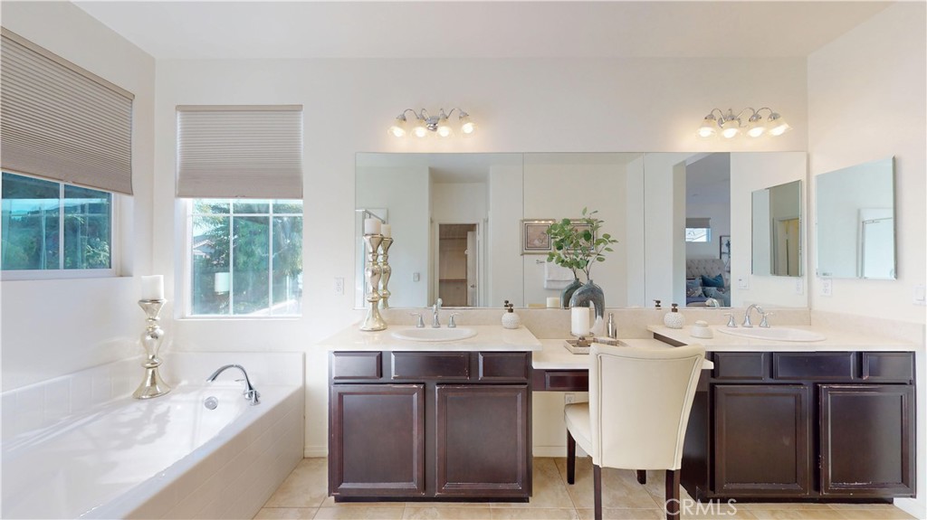 28620 Vista Del Rio Drive Valencia, CA 91354 - Photo 33 of 40 a bathroom with a sink vanity granite tub and a mirror