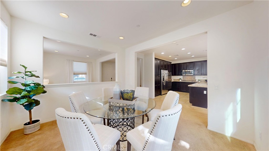 28620 Vista Del Rio Drive Valencia, CA 91354 - Photo 9 of 40 a dining room with furniture and a potted plant