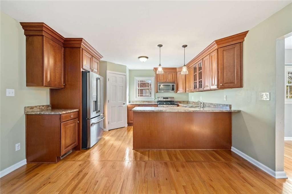 9767 Bellcrest Road Pittsburgh, PA 15237 - Photo 12 of 25 a kitchen with stainless steel appliances granite countertop a refrigerator a stove top oven and wooden floors