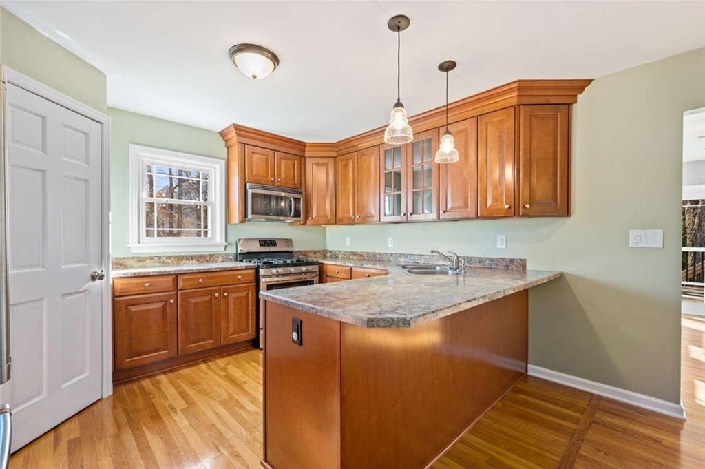 9767 Bellcrest Road Pittsburgh, PA 15237 - Photo 13 of 25 a kitchen with stainless steel appliances granite countertop a sink stove and cabinets