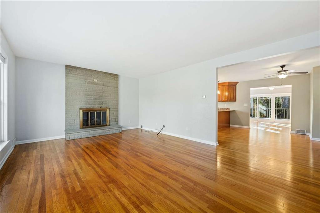 9767 Bellcrest Road Pittsburgh, PA 15237 - Photo 16 of 25 a view of empty room with wooden floor and fireplace