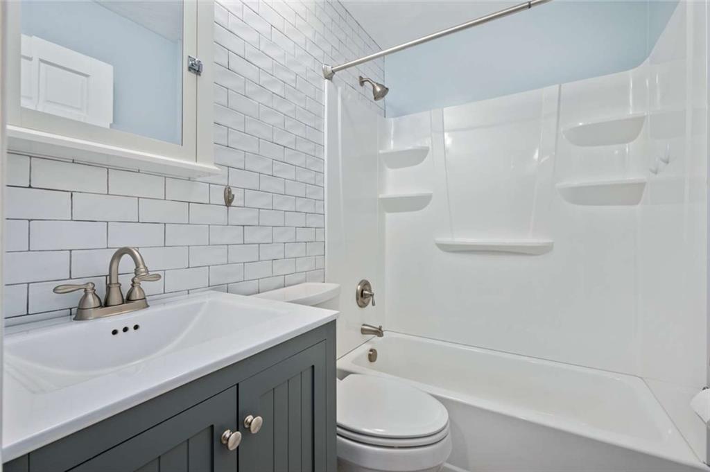 9767 Bellcrest Road Pittsburgh, PA 15237 - Photo 20 of 25 a bathroom with a sink toilet a mirror and shower