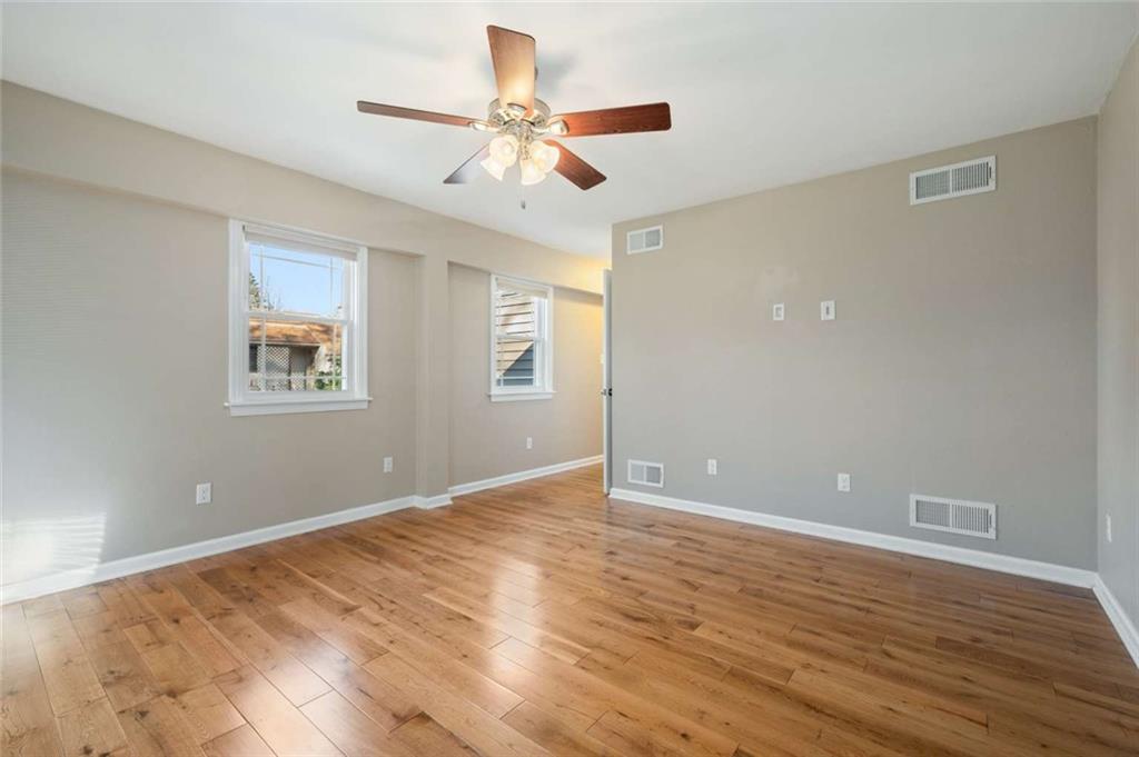 9767 Bellcrest Road Pittsburgh, PA 15237 - Photo 10 of 25 a view of an empty room with wooden floor and a ceiling fan