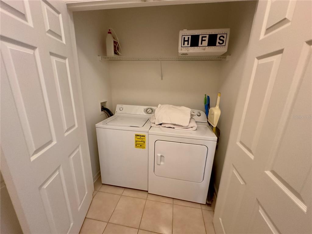 13536 Turtle Marsh Loop, Unit 532 Orlando, FL 32837 - Photo 13 of 26 a utility room with dryer and washer