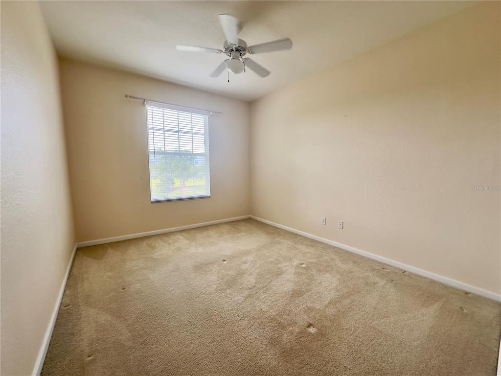 13536 Turtle Marsh Loop, Unit 532 Orlando, FL 32837 - Photo 15 of 26 an empty room with windows and fan