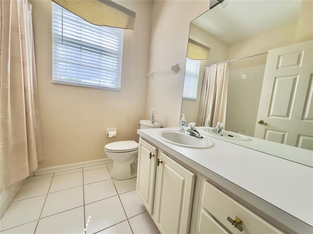 13536 Turtle Marsh Loop, Unit 532 Orlando, FL 32837 - Photo 19 of 26 a bathroom with a sink and a mirror