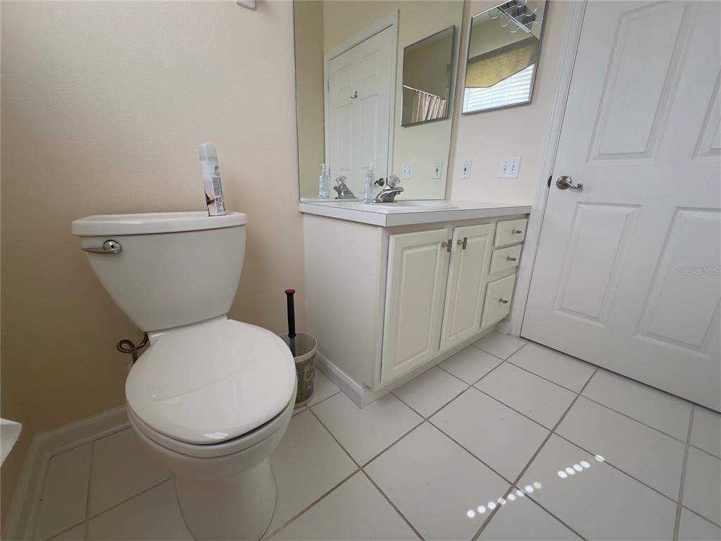 13536 Turtle Marsh Loop, Unit 532 Orlando, FL 32837 - Photo 20 of 26 a bathroom with a toilet sink and mirror