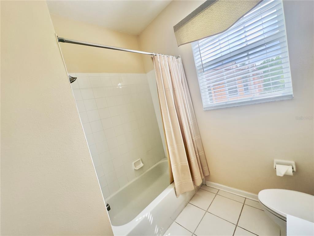 13536 Turtle Marsh Loop, Unit 532 Orlando, FL 32837 - Photo 21 of 26 a bathroom with a shower and toilet