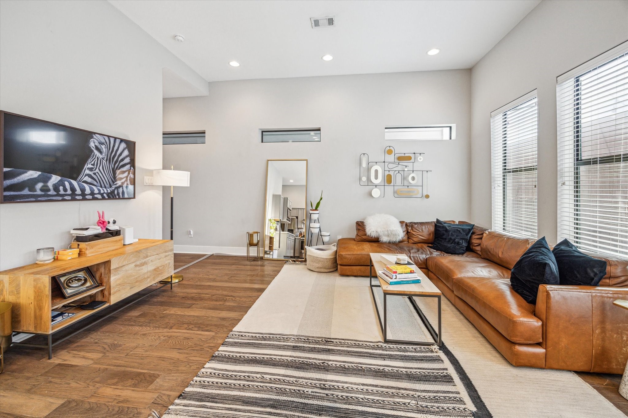 Expansive windows fill the generous open living area with natural light. Virtually staged to illustrate scale and design potential; furnishings are shown for inspiration and perspective only.
