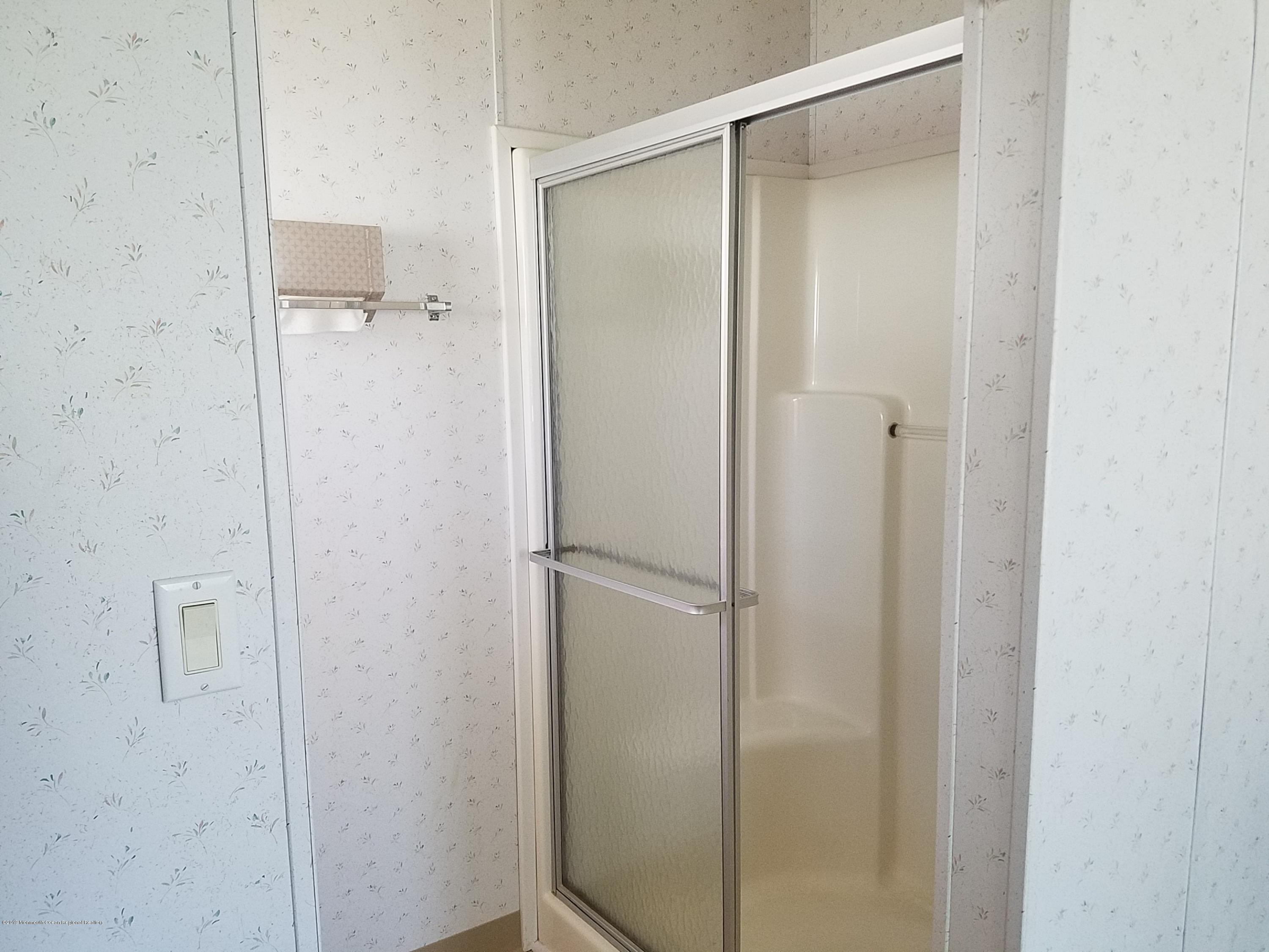 15 Village Road Morganville, NJ 07751 - Photo 11 of 12 a bathroom with a glass shower door