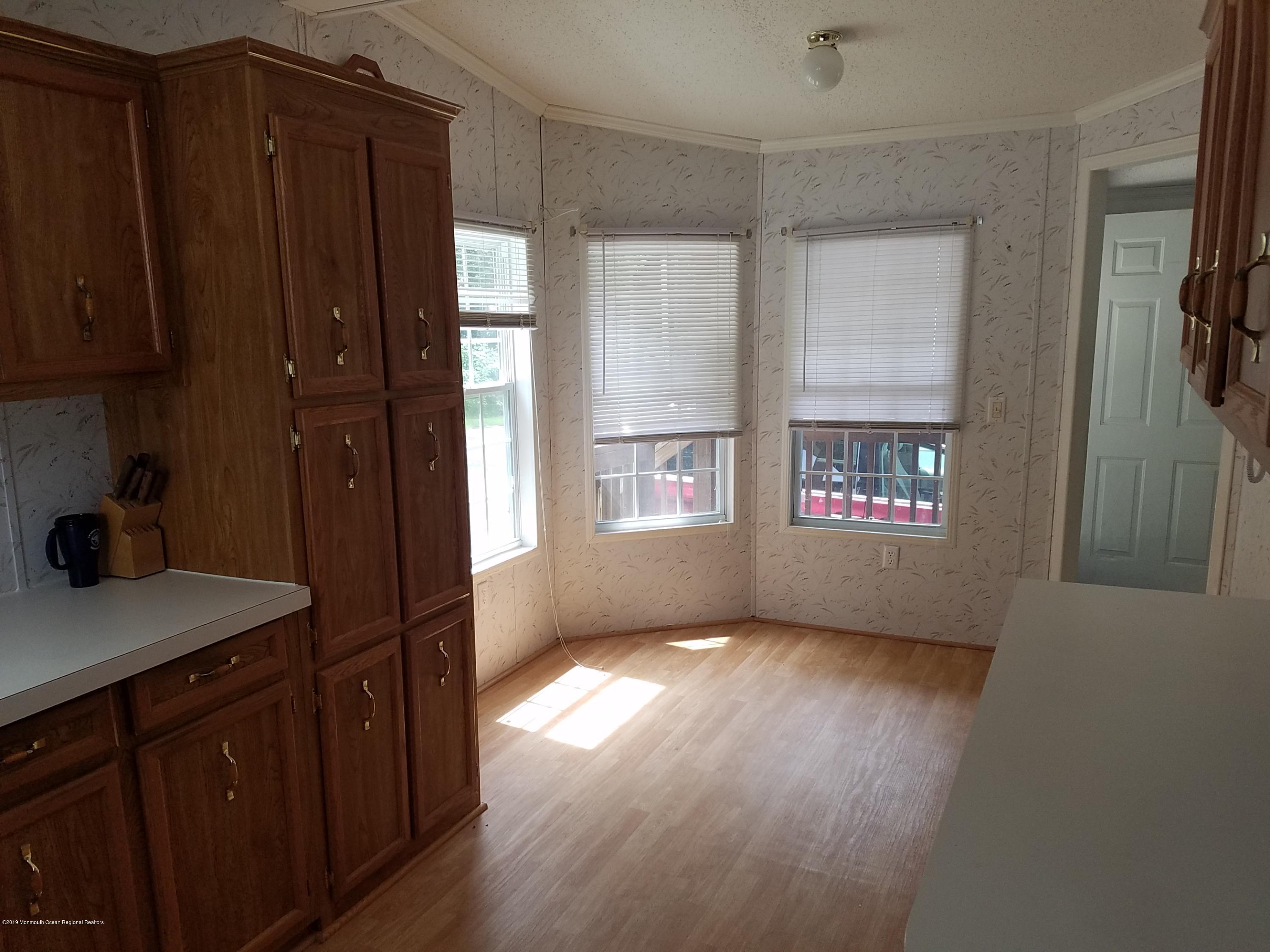 15 Village Road Morganville, NJ 07751 - Photo 4 of 12 a view of hallway with window and wooden floor