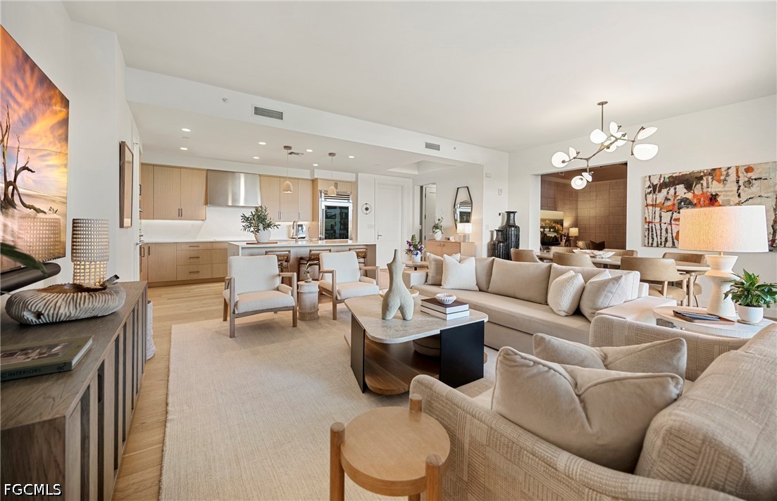 a living room with furniture and a dining table with kitchen view