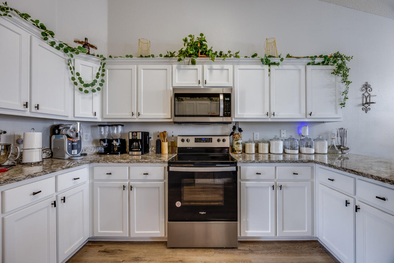 419 Triton Street Crestview, FL 32536 - Photo 22 of 60 a kitchen with granite countertop white cabinets and stainless steel appliances