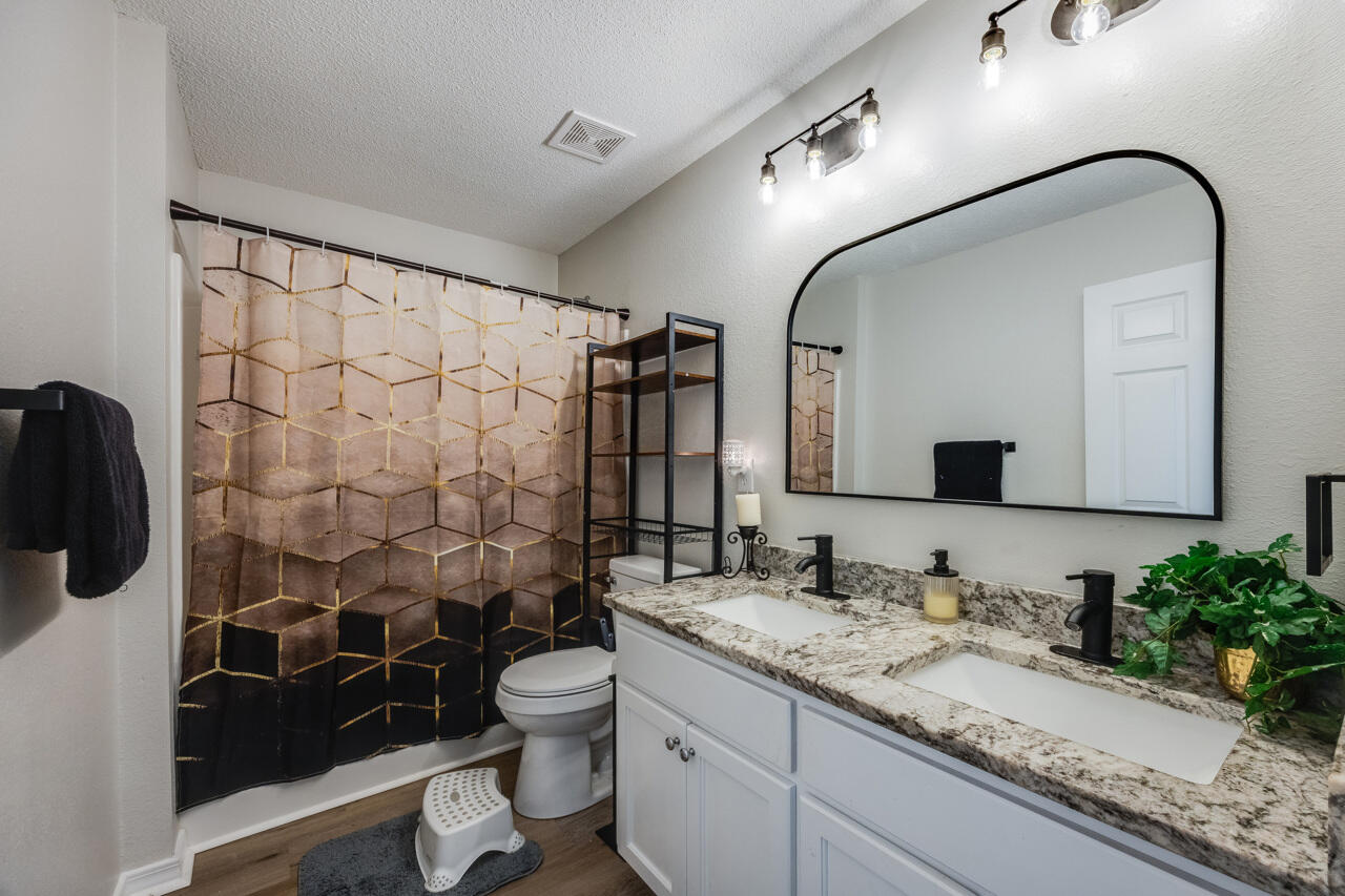 419 Triton Street Crestview, FL 32536 - Photo 45 of 60 a bathroom with a granite countertop sink toilet and shower