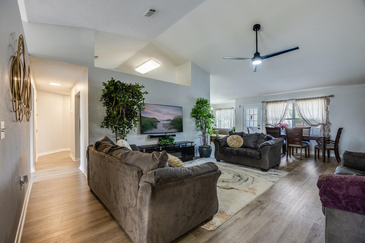 419 Triton Street Crestview, FL 32536 - Photo 8 of 60 a living room with furniture and a wooden floor