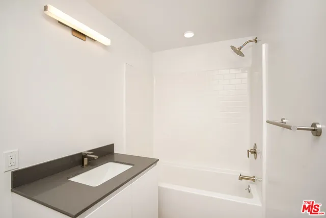 a view of a room with wooden floor and windows
