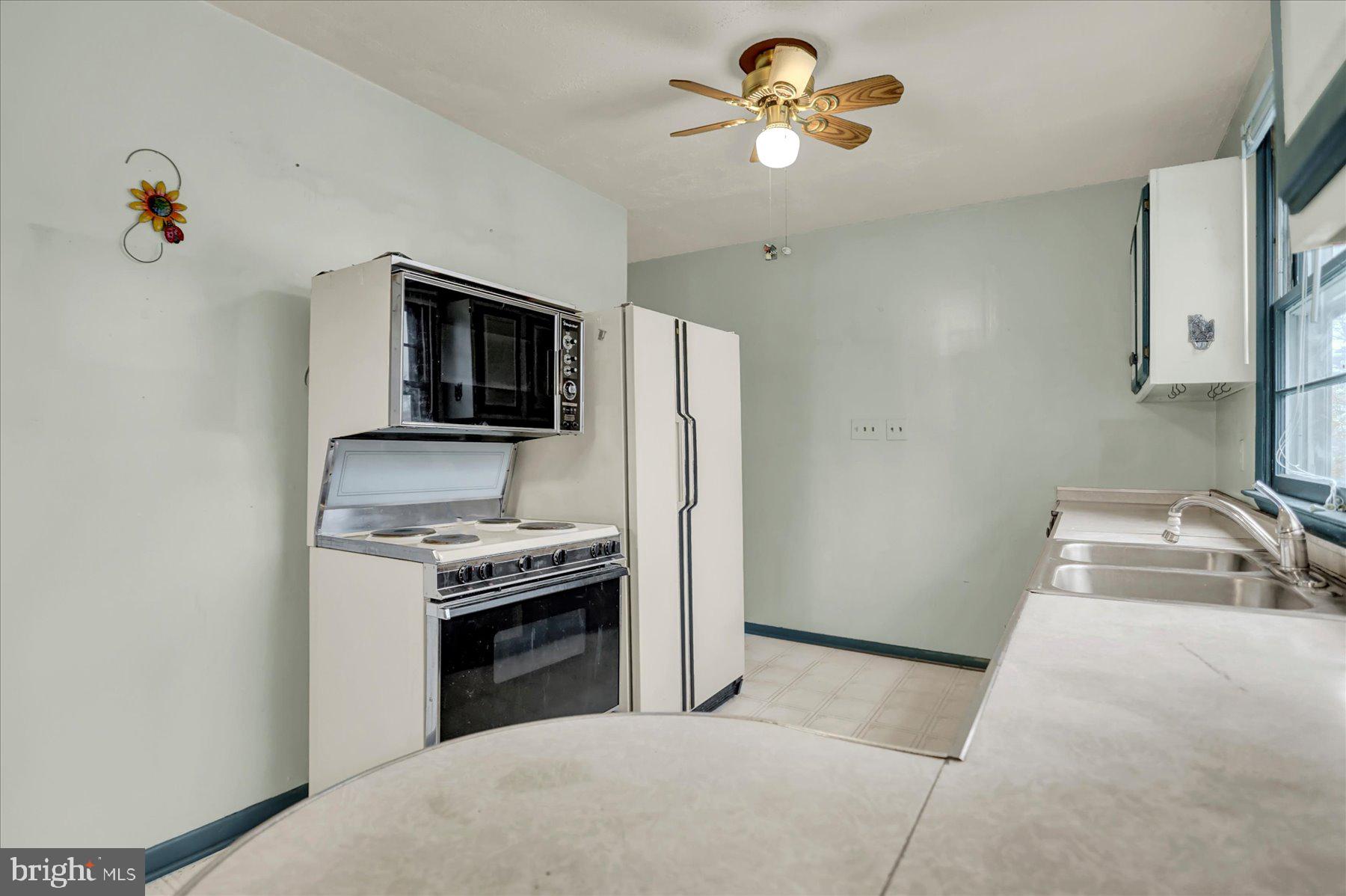 2115 White House Road Bel Air, MD 21015 - Photo 6 of 30 a kitchen with a stove and a microwave