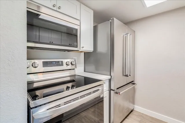 a kitchen with a stove and a microwave