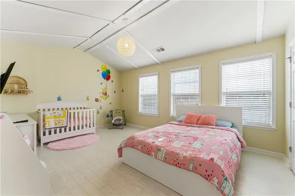 a spacious bedroom with a bed and a window