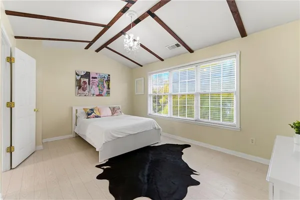 a bed sitting in a bedroom next to a window