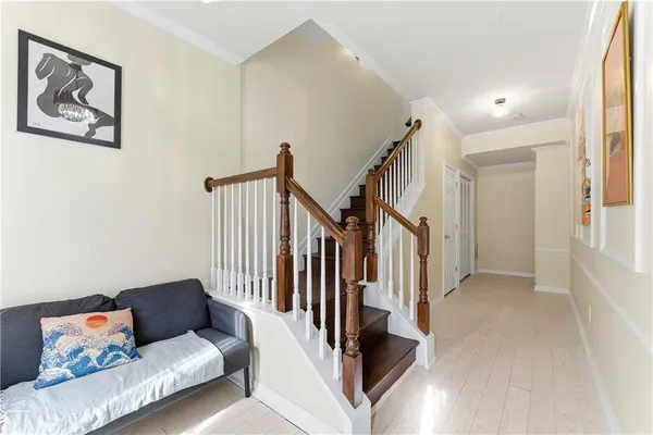 a living room with furniture and stairs