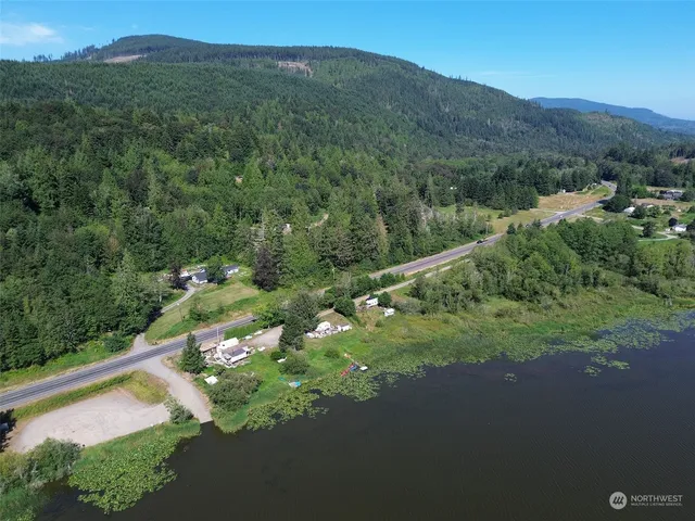 a view of a lush green hillside and a houses