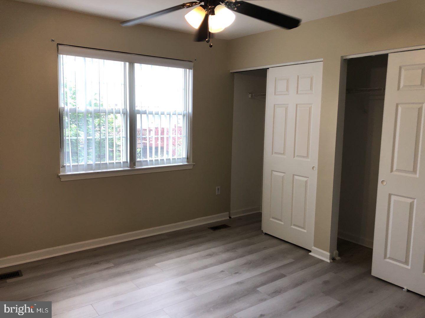 6134 Quiet Times Columbia, MD 21045 - Photo 13 of 17 a view of an empty room with wooden floor and a window