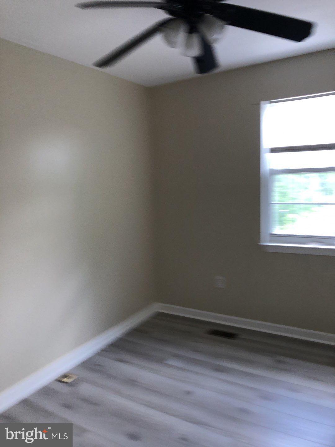 6134 Quiet Times Columbia, MD 21045 - Photo 16 of 17 a view of an empty room with wooden floor and a window