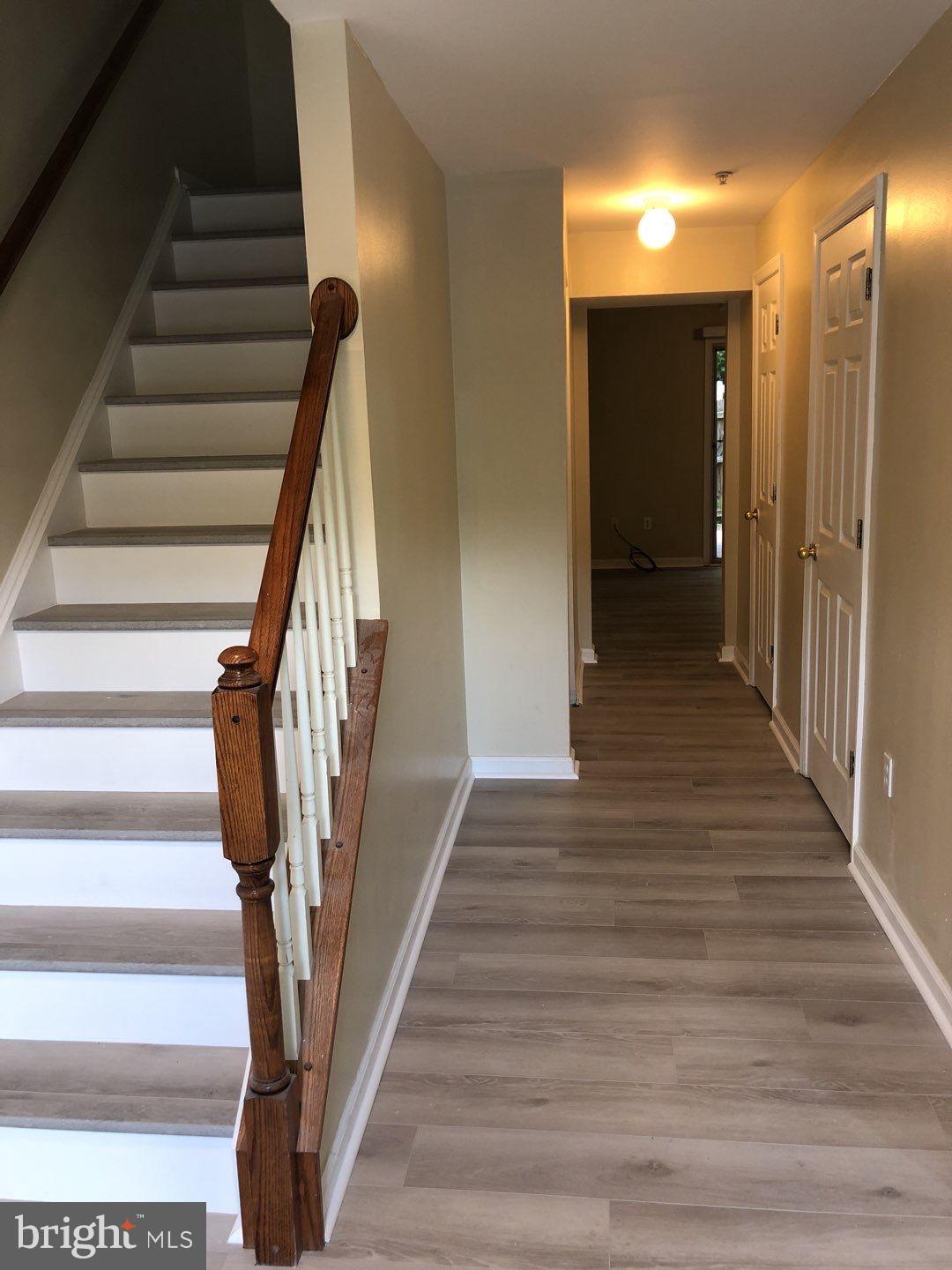 6134 Quiet Times Columbia, MD 21045 - Photo 4 of 17 a view of entryway with wooden floor and stairs