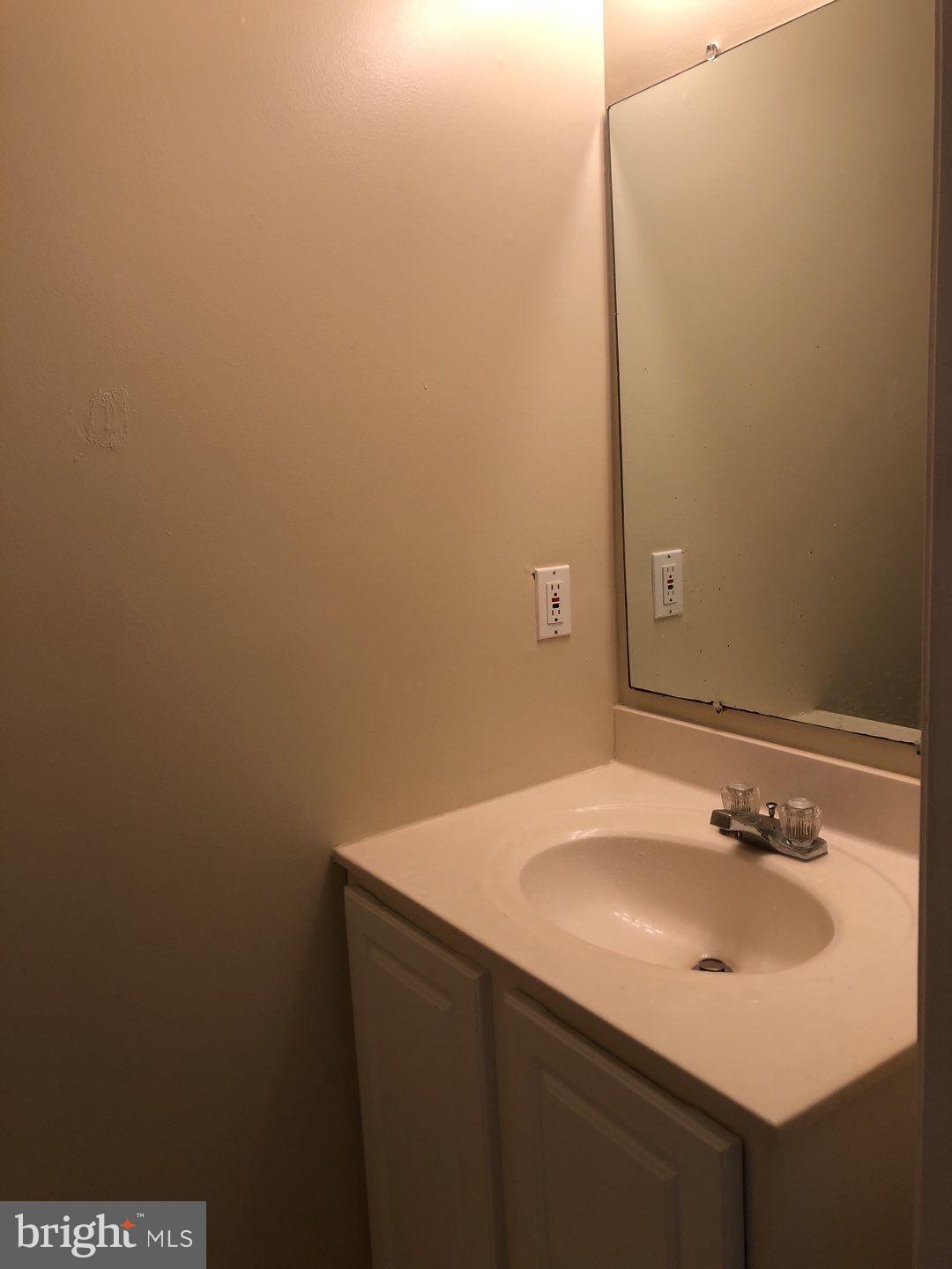 6134 Quiet Times Columbia, MD 21045 - Photo 7 of 17 a bathroom with a sink and a mirror