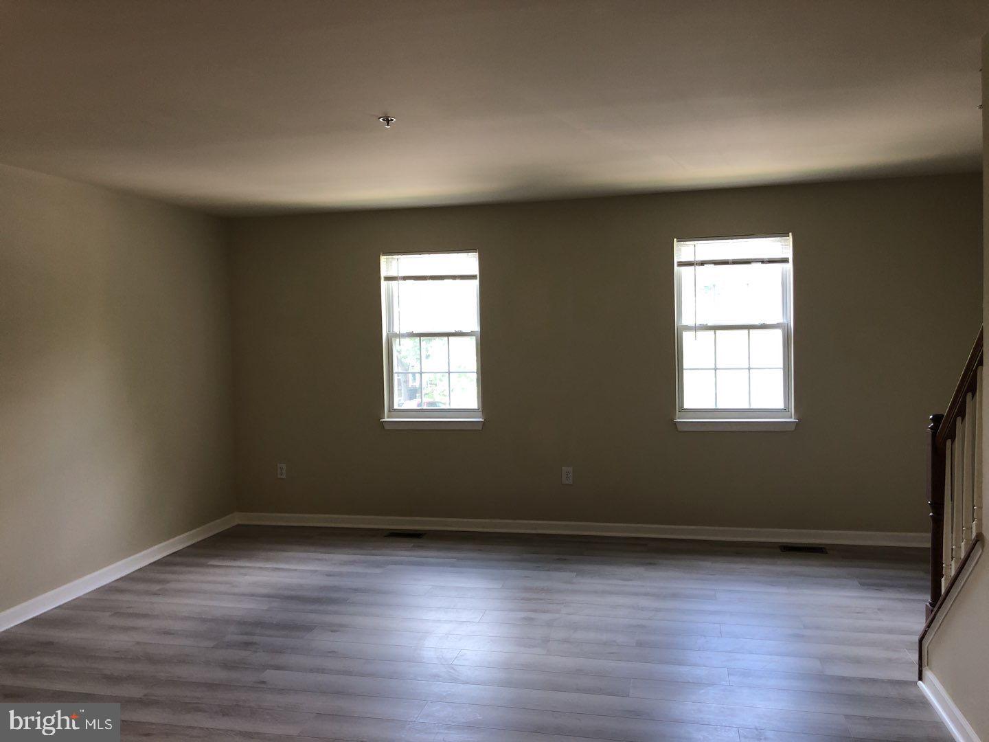 6134 Quiet Times Columbia, MD 21045 - Photo 8 of 17 an empty room with wooden floor and windows