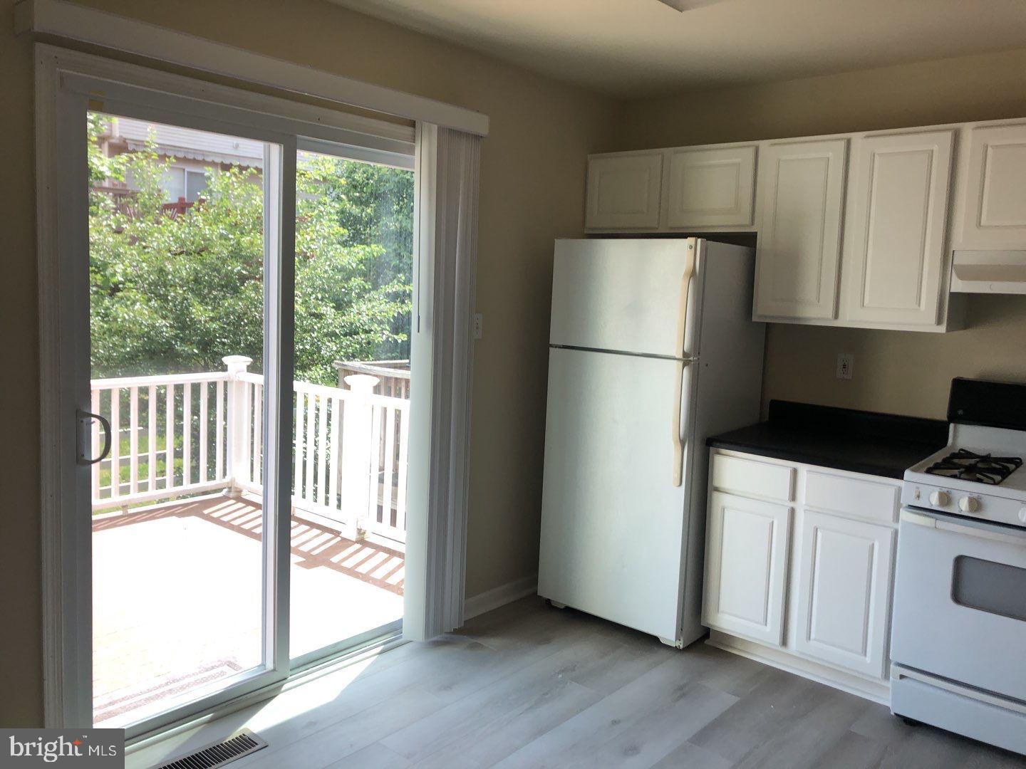 6134 Quiet Times Columbia, MD 21045 - Photo 9 of 17 a kitchen with a refrigerator a stove top oven
