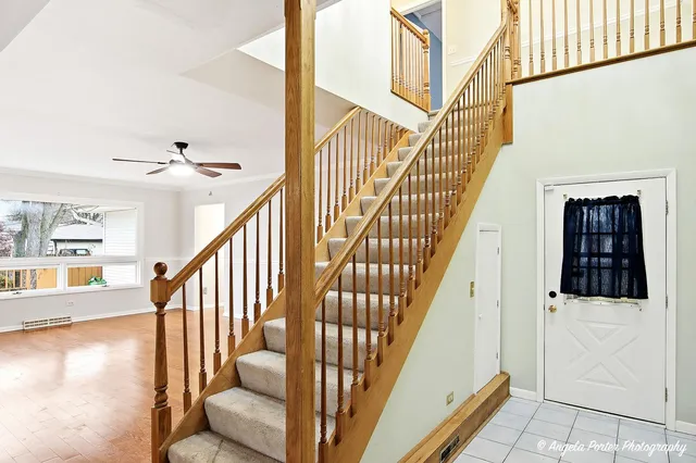 a view of entryway with wooden floor and stairs