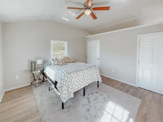 a bedroom with a bed and painting on the wall