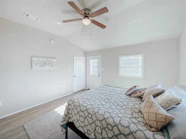 a bedroom with a bed and a window