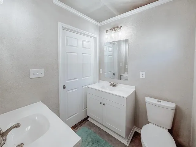 a bathroom with a sink and mirror with toilet