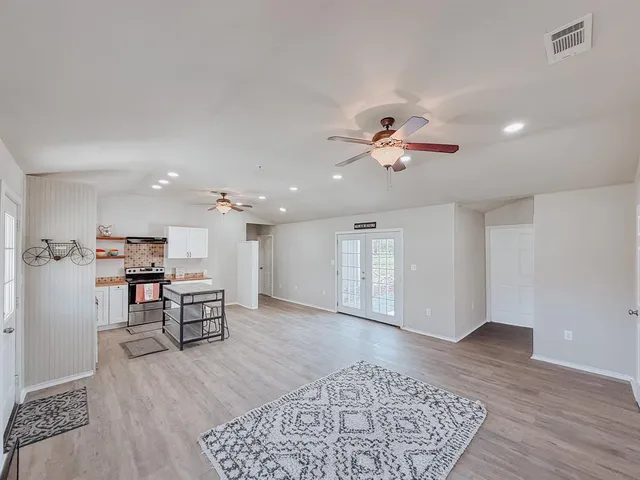a view of a livingroom with furniture and a ceiling fan