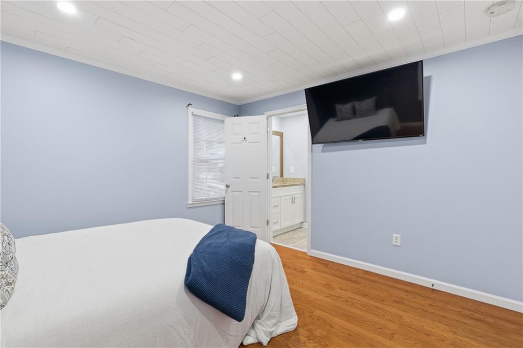 51 Perry Lane Buchanan, GA 30113 - Photo 16 of 33 a bedroom with a bed and a flat screen tv