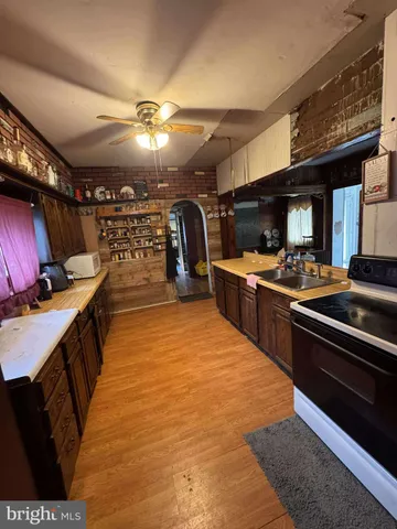 a room with furniture pool table flat screen tv and a window