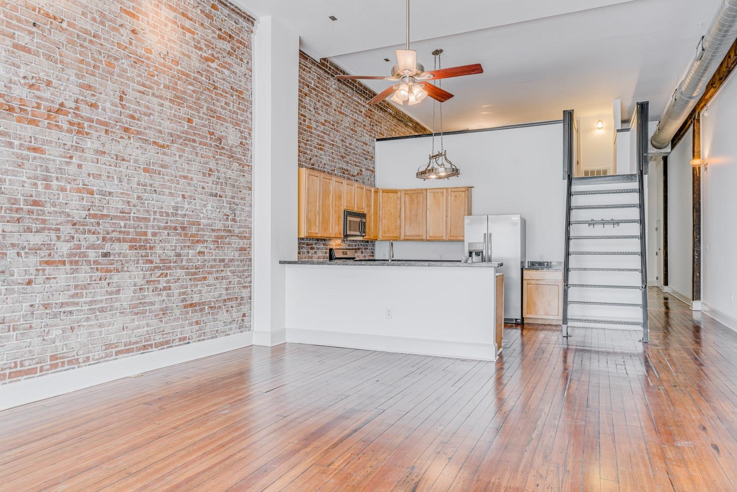 310 South Main Street, Unit 101 Memphis, TN 38103 - Photo 8 of 29 a view of a kitchen with wooden floor and a kitchen