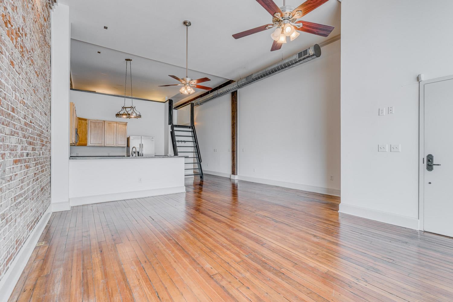 310 South Main Street, Unit 101 Memphis, TN 38103 - Photo 9 of 29 a view of a livingroom with wooden floor and a ceiling fan