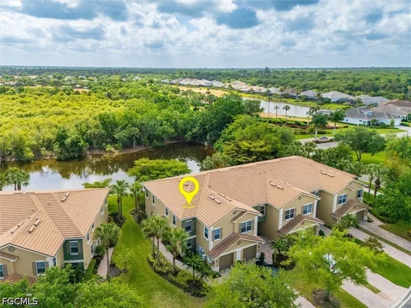 a picture of a brick house with large windows and a chandelier
