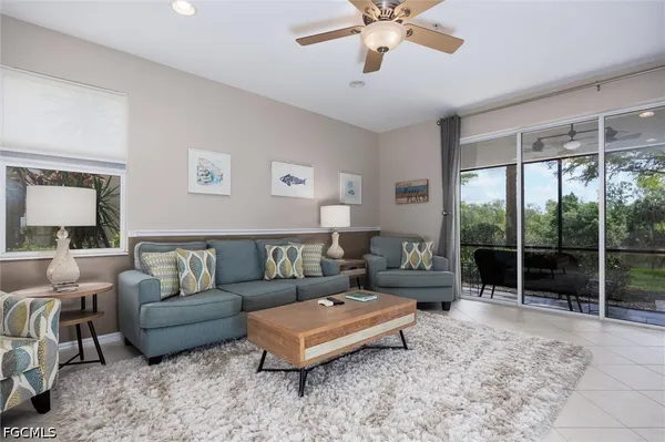 a living room with furniture and a chandelier