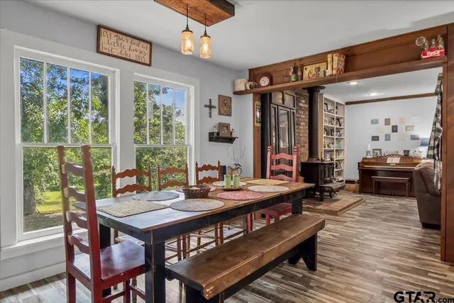 a view of a dining room with furniture large windows and wooden floor